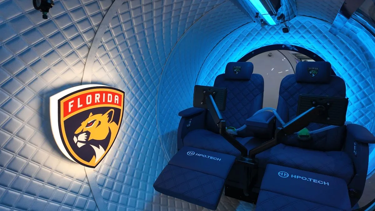 Inside a Florida Panthers HPO.TECH chamber - reclining seats, screens and HPO.TECH branding